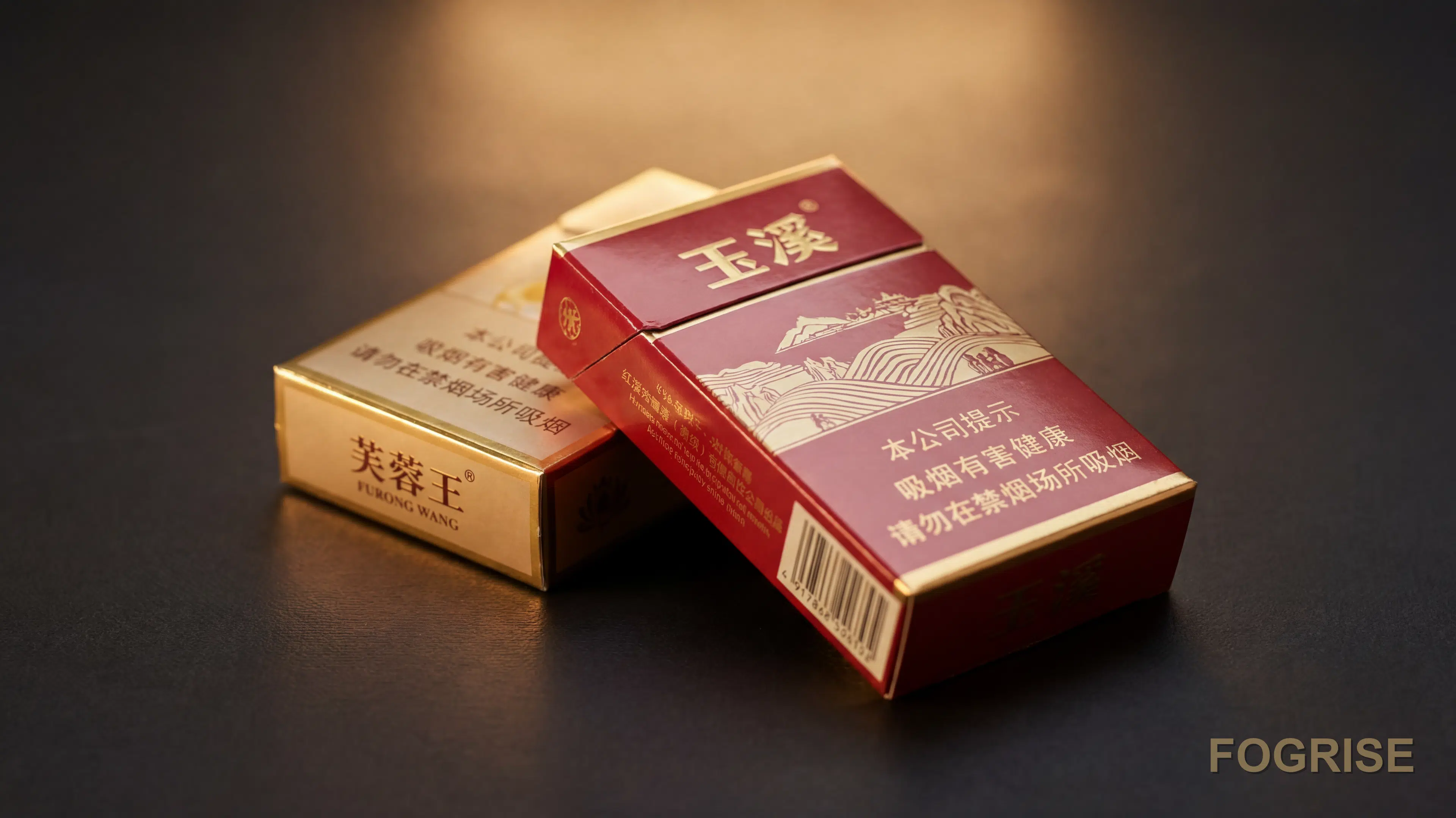 A real Yuxi (玉溪), Furong Wang (芙蓉王) cigarette pack, Two real Chinese cigarette hard packs fanned at a gentle angle on a deep