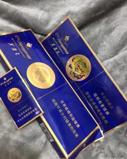 Furong Wang Hard Blue cigarette packaging, blue packs and cartons arranged together on gray fabric