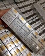 Seven Stars Charcoal cigarette packaging, two wrapped cartons held above stacked inventory