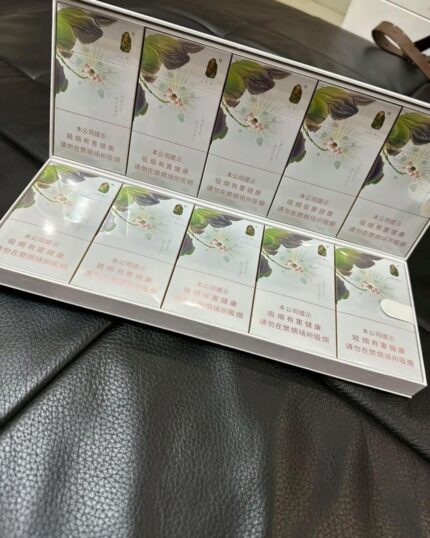Taishan Jasmine Slim cigarette packaging, packs arranged in an open carton on a black leather seat