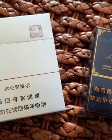 Yuxi Huaye Mid cigarette packaging, rear panel of a white pack beside a dark comparison pack