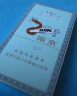 Nanjing Xuanhemen Slim cigarette packaging, angled close-up of the pale blue pack on blue fabric