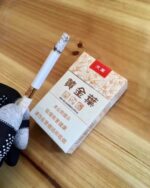 Golden Leaf Tianye Mid-Slim pack with a cigarette