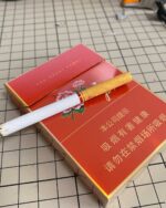 Peony Red Mid-Slim pack with a mid-slim cigarette