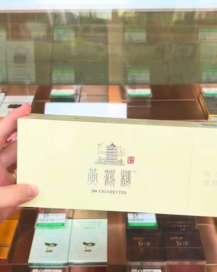 Huanghelou Canyon Tenderness cigarette packaging, open cream carton held above a retail counter