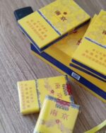 Nanjing Soft 95 Slim cigarette packaging, several opened yellow packs and cigarettes on a tabletop