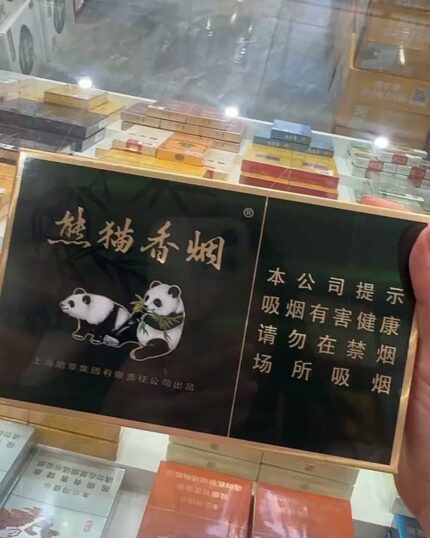 Panda Classic Mid cigarette packaging, two dark green panda packs held over a retail counter