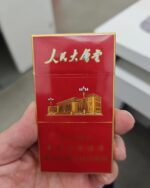 Great Hall Red Slim cigarette packaging, front of the red and gold pack held in one hand