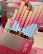 Suyan Duocai Mid-Slim cigarette packaging, opened silver and red pack showing pink and white cigarettes